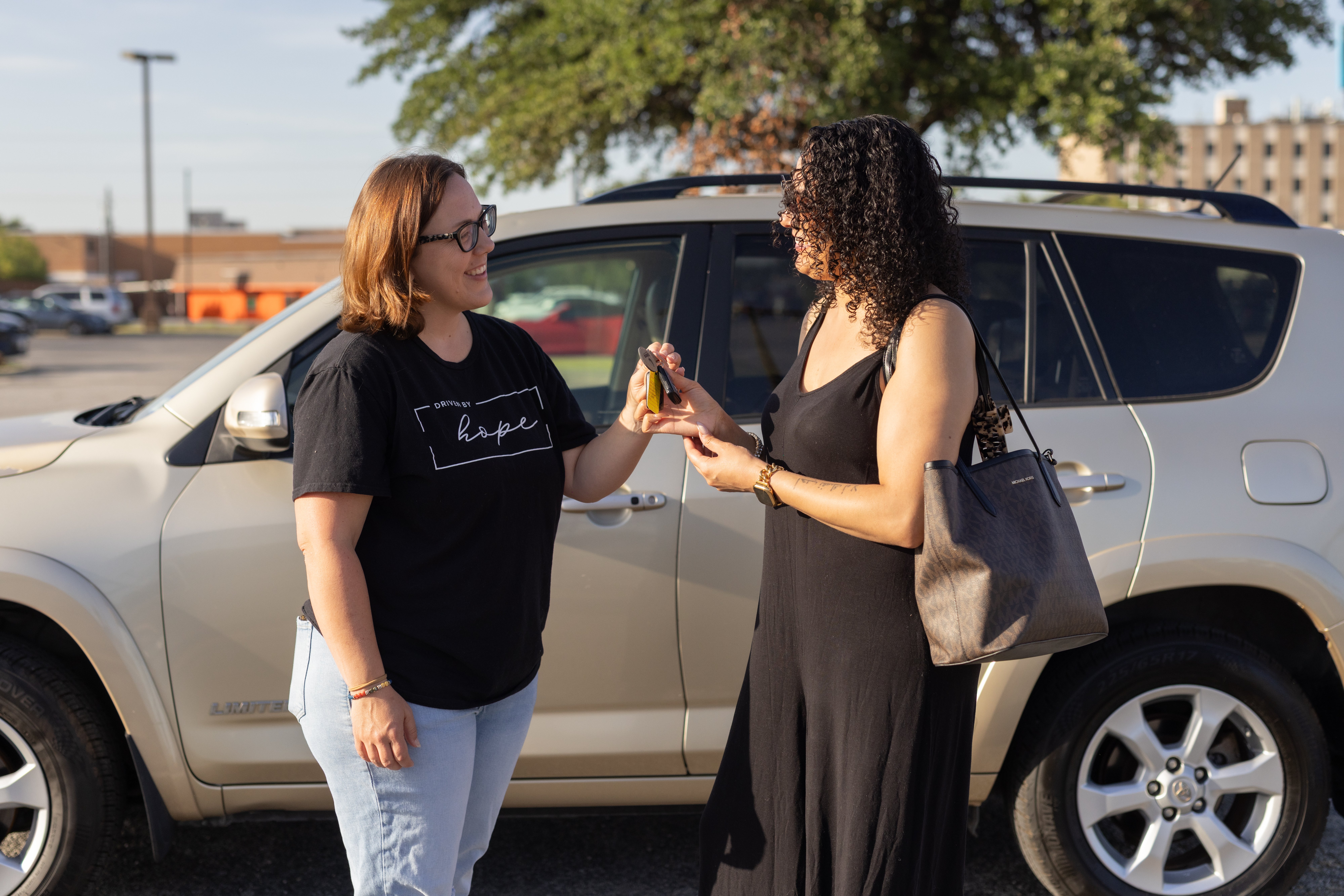 OnRamp volunteer handing car keys to a client